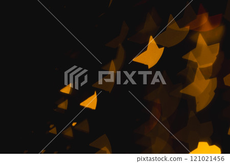 Yellow star bokeh lights with copy space on dark background 121021456