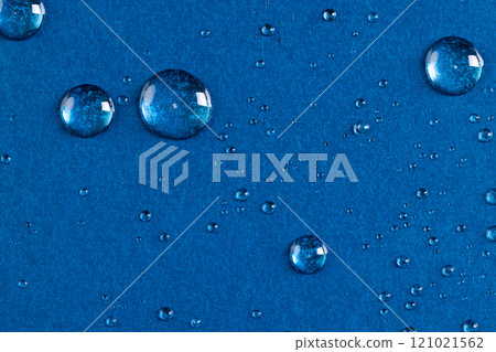 Micro close up of water drops with copy space on blue background 121021562