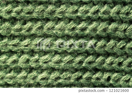 Micro close up of green wooly knitted fabric with copy space Micro close up of green wooly knitted fabric with copy space 121021600