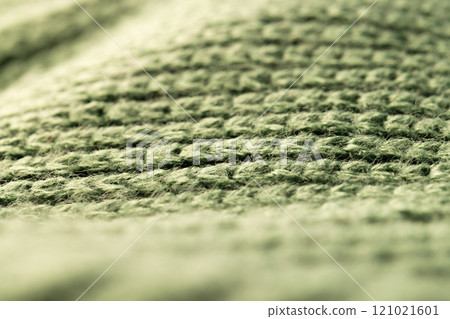 Micro close up of green wooly knitted fabric with copy space Micro close up of green wooly knitted fabric with copy space 121021601