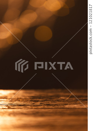 Vertical image of yellow bokeh blurred lights with copy space and wooden surface on dark background Vertical image of yellow bokeh blurred lights with copy space and wooden surface on dark background 121021817