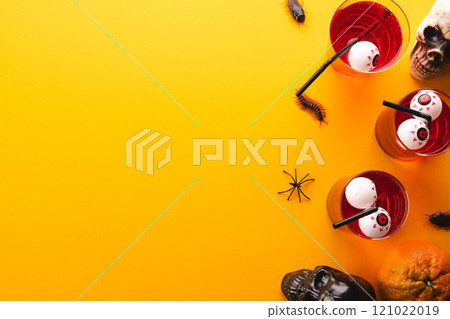 Halloween decorations and food with copy space on yellow background Halloween decorations and food with copy space on yellow background 121022019