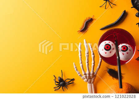 Halloween decorations and food with copy space on yellow background Halloween decorations and food with copy space on yellow background 121022028