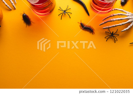 Halloween decorations and food with copy space on yellow background Halloween decorations and food with copy space on yellow background 121022035