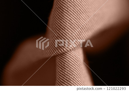 Close up of twisted brown fabric texture with detailed fibers in soft lighting Close up of twisted brown fabric texture with detailed fibers in soft lighting 121022293