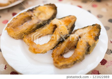 Three pieces of fried carp on a white plate Three pieces of fried carp on a white plate 121022869