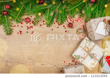 Christmas gift box, food decor and fir tree branch on wooden table. Christmas holiday card. top view. copy space 121023044