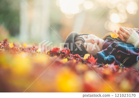Autumn leaves and a young lady 121023170