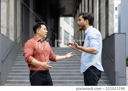 An intense exchange between two colleagues on office stairs captures a moment of workplace conflict. The image reflects emotions such as anger and stress, highlighting professional disagreements. 121023190
