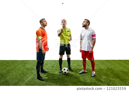 Referee standing between to players from opposite teams and tossing a coin to determine which team will kick off first 121023559