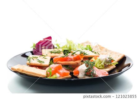 small snack canapes with crackers and lightly salted red fish Salmon, isolated on white background small snack canapes with crackers and lightly salted red fish Salmon, isolated on white background 121023855