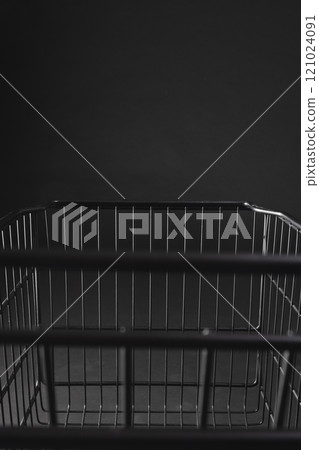 Vertical image of shopping trolley with copy space over black background 121024091
