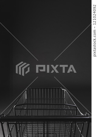 Vertical image of shopping trolley with copy space over black background 121024092