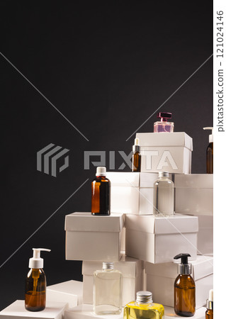Vertical image of boxes with beauty products and copy space over black background 121024146