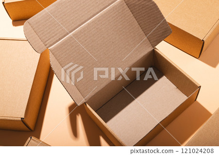Open box, boxes and copy space over cream background 121024208