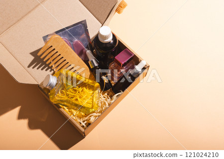 Box with beauty products and copy space over cream background Box with beauty products and copy space over cream background 121024210