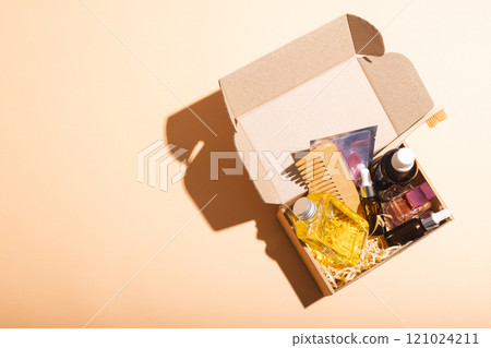 Box with beauty products and copy space over cream background 121024211