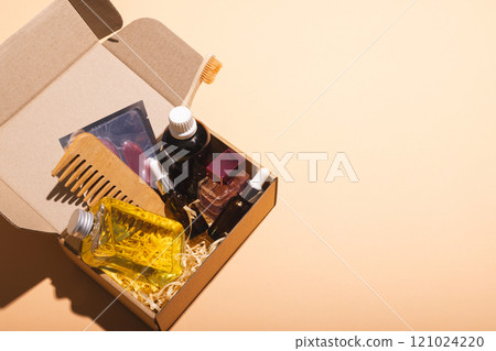 Box with beauty products and copy space over cream background Box with beauty products and copy space over cream background 121024220