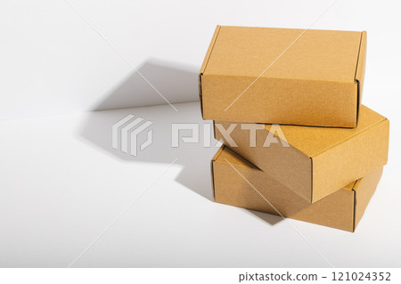 Stack of cardboard gift boxes with copy space over white background Stack of cardboard gift boxes with copy space over white background 121024352