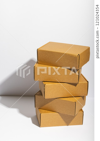 Vertical image of stack of cardboard gift boxes with copy space over white background Vertical image of stack of cardboard gift boxes with copy space over white background 121024354