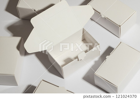 Open cardboard gift box and boxes with copy space over white background 121024370