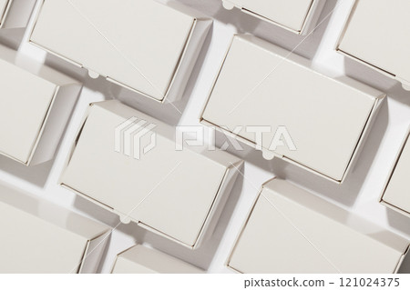 Rows of cardboard gift boxes with copy space over white background 121024375