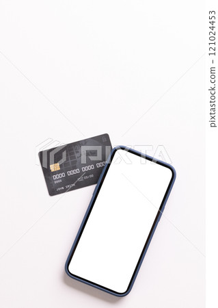 Vertical image of smartphone with blank screen and credit card on white background 121024453