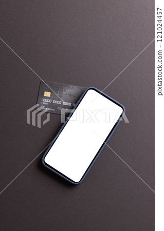 Vertical image of smartphone with blank screen and credit card on black background Vertical image of smartphone with blank screen and credit card on black background 121024457