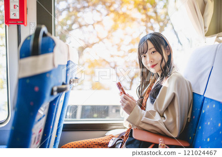 Young woman on a bus looking out the window Young woman on a bus looking out the window 121024467