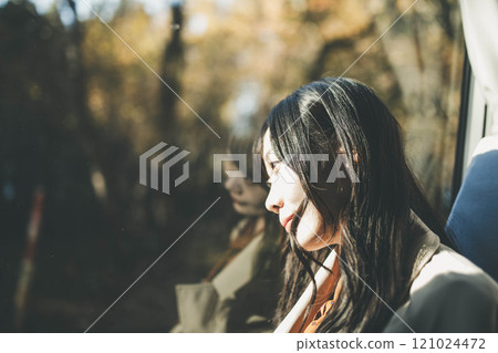 Young woman on a bus looking out the window 121024472
