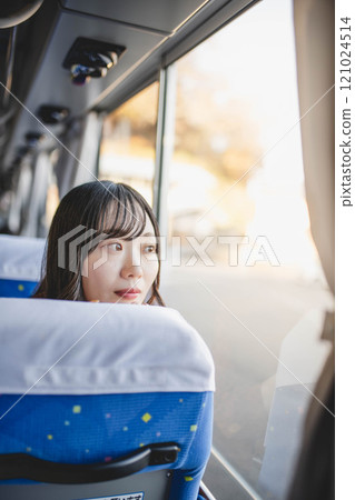 Young woman on a bus looking out the window Young woman on a bus looking out the window 121024514