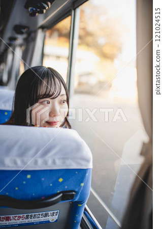Young woman on a bus looking out the window Young woman on a bus looking out the window 121024515