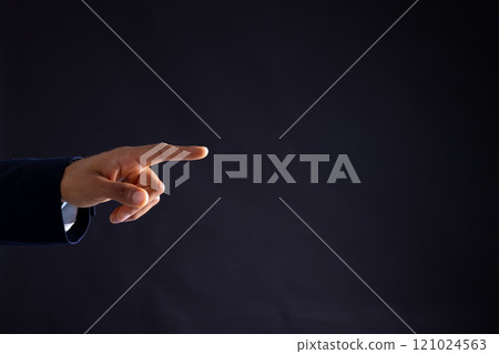 Hand of biracial businessman pointing with copy space on black background 121024563