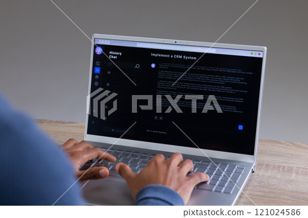 Biracial businessman using laptop with data on grey background Biracial businessman using laptop with data on grey background 121024586