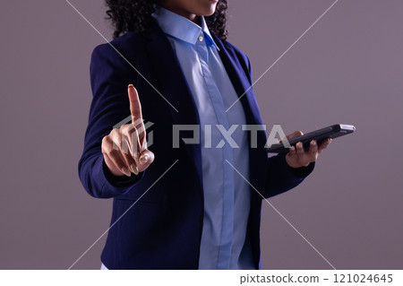 Biracial businesswoman using smartphone with copy space on grey background 121024645