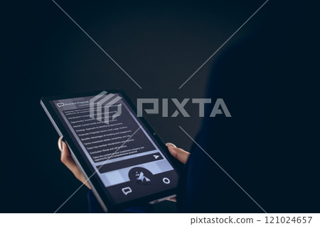Biracial businesswoman using tablet with copy space on black background Biracial businesswoman using tablet with copy space on black background 121024657