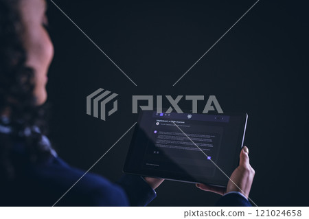 Biracial businesswoman using tablet with copy space on black background Biracial businesswoman using tablet with copy space on black background 121024658