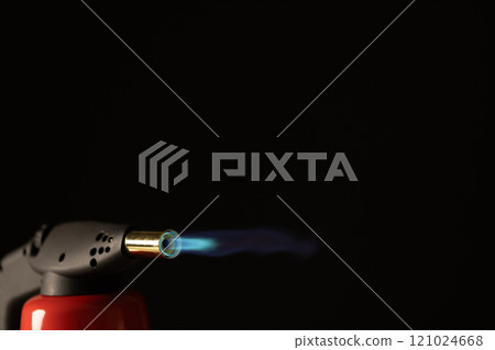 Close up of lit torch light with copy space on black background Close up of lit torch light with copy space on black background 121024668
