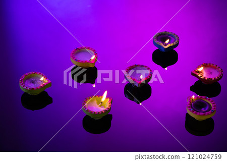 Close up of seven diwali candles with copy space on purple background Close up of seven diwali candles with copy space on purple background 121024759