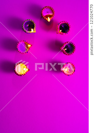Close up of seven diwali candles with copy space on purple background 121024770