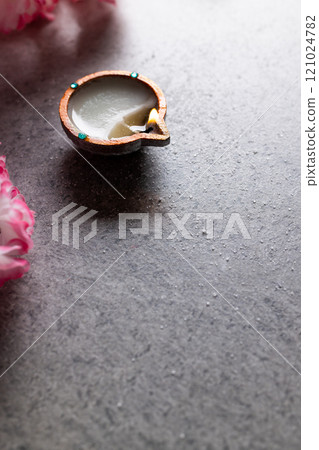 Close up of diwali candle with copy space on grey background Close up of diwali candle with copy space on grey background 121024782