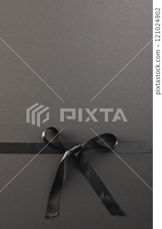 Black gift ribbon and bow with copy space on black background Black gift ribbon and bow with copy space on black background 121024902