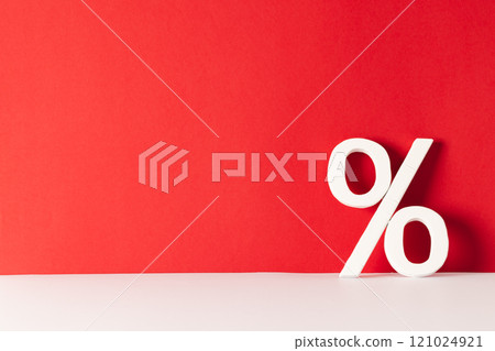 White percent sign with copy space against red background White percent sign with copy space against red background 121024921