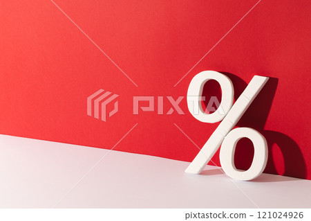 White percent sign with copy space against red background White percent sign with copy space against red background 121024926