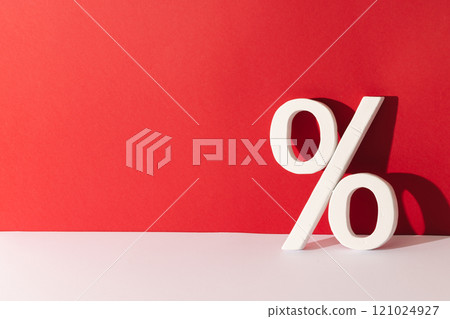 White percent sign with copy space against red background White percent sign with copy space against red background 121024927
