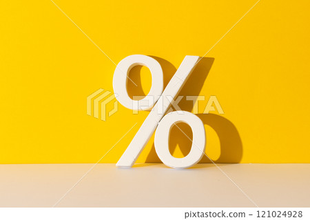 White percent sign with copy space against yellow background White percent sign with copy space against yellow background 121024928