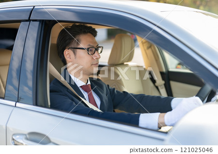 Male driver driving Male driver driving 121025046