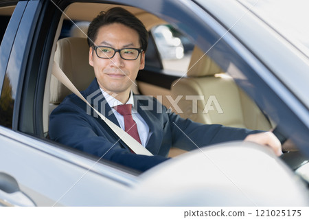 Businessman riding a car 121025175