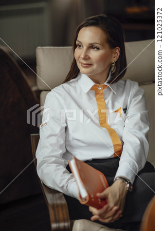 poised leader with a notebook, symbolizing planning and readiness. leader, engaged in strategic planning poised leader with a notebook, symbolizing planning and readiness. leader, engaged in strategic planning 121025372