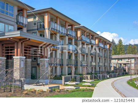 New residential apartment building with walkway and bike route in front on sunny day in British Columbia, Canada New residential apartment building with walkway and bike route in front on sunny day in British Columbia, Canada 121025443